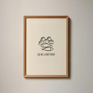 Op de afbeelding: Een ingelijste wandprint met een zwarte lijntekening van vijf broden en twee vissen, gecentreerd op een crèmekleurige achtergrond. Onder de illustratie staat de tekst GOD WILL ALWAYS PROVIDE in een eenvoudig, strak, zwart schreefloos lettertype.
