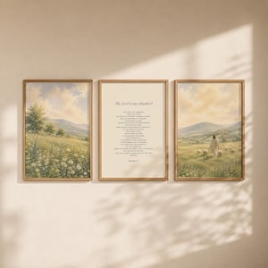May include: A set of three framed wall art prints. The left and right prints feature a landscape painting of a grassy field with wildflowers, rolling hills, and a figure with sheep. The centre print displays the text of Psalm 23 in black font.