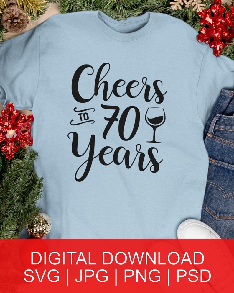 May include: A light blue t-shirt with the text "Cheers to 70 years" in black lettering and a wine glass graphic.