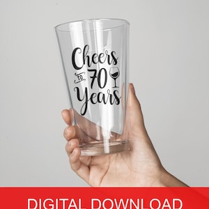 May include: A clear glass with a black vinyl decal that says "Cheers to 70 Years" with a wine glass icon.