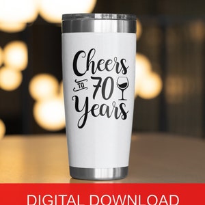 May include: White stainless steel tumbler with a black design that says "Cheers to 70 Years" with a wine glass icon.