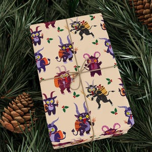 Wrapped gift box with Krampus wrapping paper surrounded by pinecones on greenery
