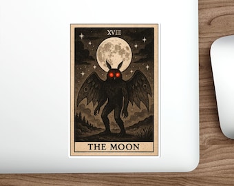 May include: A sticker with a tarot card illustration. The card shows a black, winged figure with red eyes, set against a full moon and starry sky. The card is labelled "XVIII" and "THE MOON", with a vintage style and a cream-colored background.