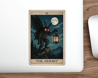 May include: A sticker featuring a tarot card illustration. The card shows a dark, winged creature holding a lantern under a full moon. The card is labelled "IX" at the top and "THE HERMIT" at the bottom, with a border.