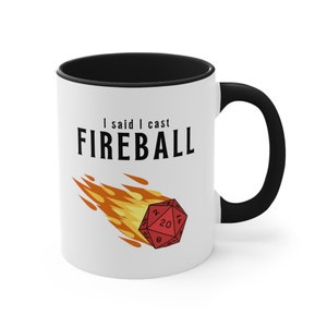 A white ceramic mug with a flaming D20 on it for dungeons and dragons DnD that says I didnt ask how big the room is on one side and I said I cast FIREBALL on the other