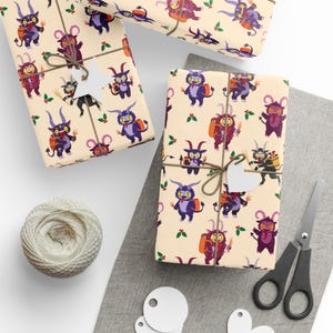 Sheets of Krampus wrapping paper with cartoon Krampuses on beige background, tied with string next to scissors and gift tags