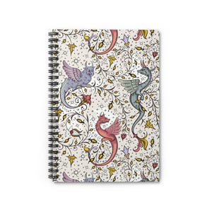 May include: A spiral bound notebook with a white background and a repeating pattern of colorful dragons and floral vines. The dragons are in shades of blue, red, and purple.
