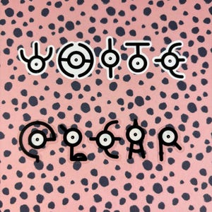 May include: Ten black and white stickers featuring different designs of a single eye with a circle around it. The stickers are on a pink background with black polka dots.