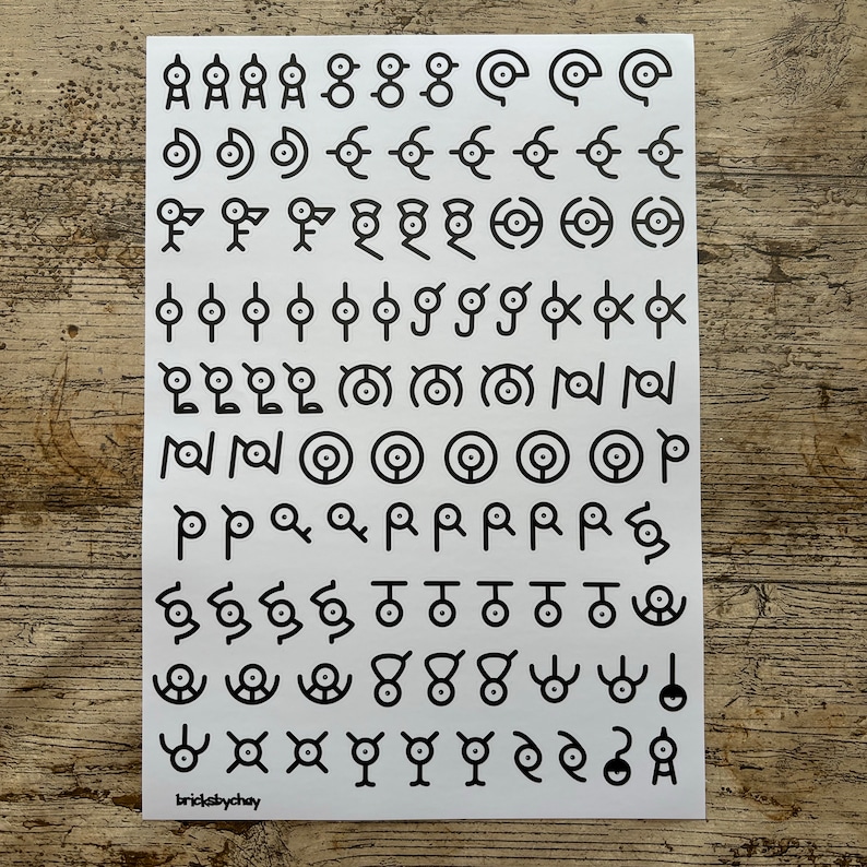 May include: A white sheet of paper with black symbols printed on it. The symbols are various shapes and designs, including circles, squares, and triangles. The text "bricksbychay" is printed in the bottom left corner.