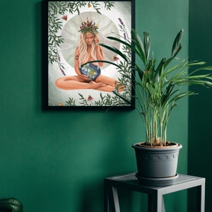 May include: A framed print of a woman sitting with a crown of leaves on her head, holding a globe in her hands. The background is a green and white illustration of leaves and flowers.
