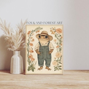 May include: A whimsical illustration of a frog wearing a straw hat and overalls, surrounded by delicate pink and white flowers. The artwork is titled "Folk and Forest Art".