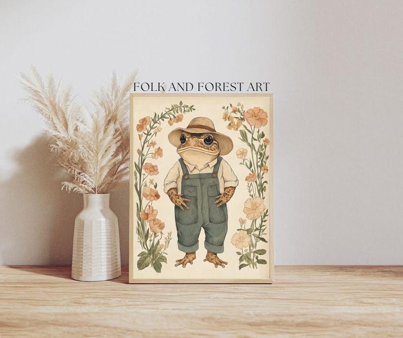 May include: A whimsical illustration of a frog wearing a straw hat and overalls, surrounded by delicate pink and white flowers. The artwork is titled "Folk and Forest Art".