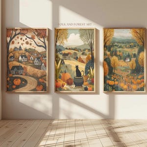May include: Three framed art prints with a fall theme. The prints depict rural landscapes with pumpkins, trees, and houses. The middle print features a black cat. The text "FOLK AND FOREST ART" is visible.
