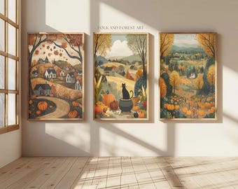 May include: Three framed art prints with a fall theme. The prints depict rural landscapes with pumpkins, trees, and houses. The middle print features a black cat. The text "FOLK AND FOREST ART" is visible.