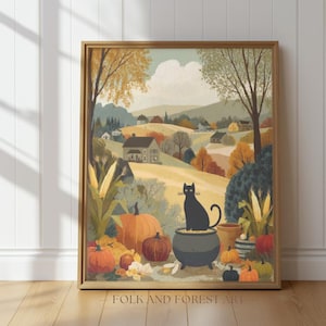 May include: A framed autumn-themed print featuring a black cat perched on a cauldron, surrounded by pumpkins and fall foliage. The artwork depicts a rural landscape with houses and trees in warm colors. The text "FOLK AND FOREST ART" is at the bottom.