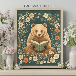 A cozy folk art illustration featuring a brown bear sitting among wildflowers, holding an ornate green book. The green background complements the warm tones of the bear and florals. Perfect for book lovers, woodland nursery decor, and cottagecore.