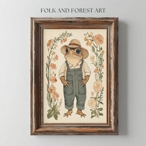 May include: A framed illustration of a toad wearing a straw hat and overalls, standing in a field of flowers. The toad is brown with green eyes and a wide smile. The flowers are pink and white, and the background is a light beige.