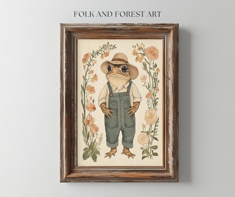 May include: A framed illustration of a toad wearing a straw hat and overalls, standing in a field of flowers. The toad is brown with green eyes and a wide smile. The flowers are pink and white, and the background is a light beige.