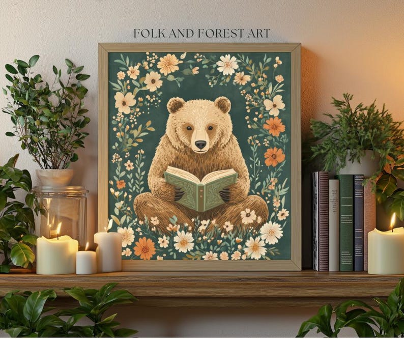 A cozy folk art illustration featuring a brown bear sitting among wildflowers, holding an ornate green book. The green background complements the warm tones of the bear and florals. Perfect for book lovers, woodland nursery decor, and cottagecore.