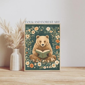 A cozy folk art illustration featuring a brown bear sitting among wildflowers, holding an ornate green book. The green background complements the warm tones of the bear and florals. Perfect for book lovers, woodland nursery decor, and cottagecore.