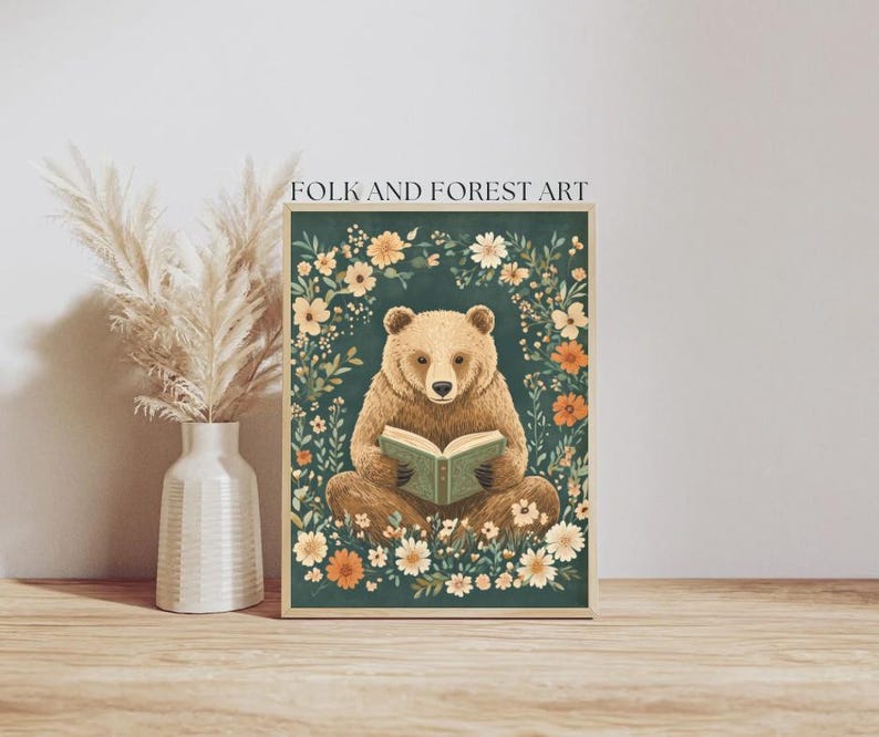 A cozy folk art illustration featuring a brown bear sitting among wildflowers, holding an ornate green book. The green background complements the warm tones of the bear and florals. Perfect for book lovers, woodland nursery decor, and cottagecore.