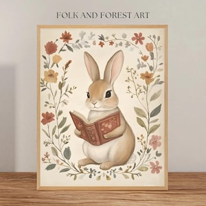 May include: A watercolour illustration of a brown rabbit reading a book surrounded by a wreath of flowers in shades of pink, orange, and green. The text "FOLK AND FOREST ART" is at the top of the image.