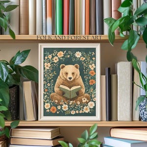A cozy folk art illustration featuring a brown bear sitting among wildflowers, holding an ornate green book. The green background complements the warm tones of the bear and florals. Perfect for book lovers, woodland nursery decor, and cottagecore.