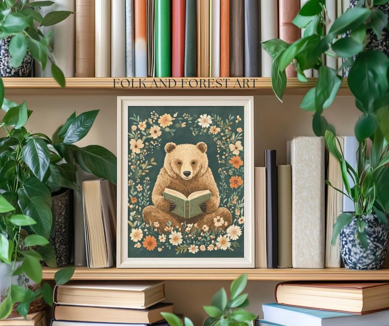 A cozy folk art illustration featuring a brown bear sitting among wildflowers, holding an ornate green book. The green background complements the warm tones of the bear and florals. Perfect for book lovers, woodland nursery decor, and cottagecore.