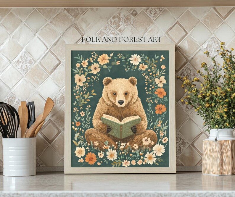 A cozy folk art illustration featuring a brown bear sitting among wildflowers, holding an ornate green book. The green background complements the warm tones of the bear and florals. Perfect for book lovers, woodland nursery decor, and cottagecore.