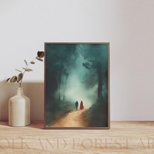 May include: A framed painting of a couple walking through a misty forest. The man is wearing a blue jacket and the woman is wearing a red cloak. The forest is a dark green and the mist is a light blue.