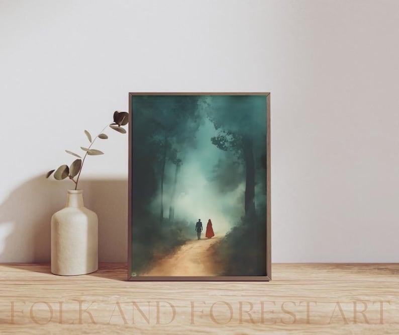 May include: A framed painting of a couple walking through a misty forest. The man is wearing a blue jacket and the woman is wearing a red cloak. The forest is a dark green and the mist is a light blue.