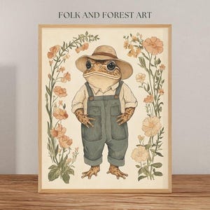 May include: A whimsical illustration of a toad wearing a straw hat and overalls, surrounded by delicate wildflowers in shades of pink and yellow. The toad is smiling and has a friendly expression. The artwork is framed in a light wood frame.