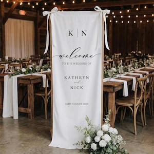 May include: A white ceramic mug with a black handle and the text "But First, Coffee" in a black, bold font. The mug is on a white surface.