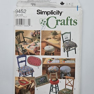 May include: A Simplicity Crafts pattern envelope showcasing chair seat cover designs. The envelope shows chairs with diverse fabric patterns, such as floral, animal print, and gingham. The pattern number is 9452, and the designer is Donna Lang.