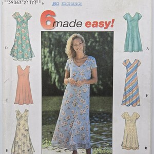 May include: A Simplicity sewing pattern featuring six dress designs. The cover shows a woman wearing a blue floral dress. The text "6 made easy!" is prominently displayed. The dresses are in various colors and styles.
