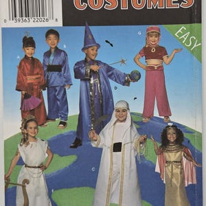 May include: A Simplicity Costumes sewing pattern envelope 8303 for sizes S, M, L featuring illustrations of children wearing various costumes including a wizard, a genie, and historical outfits against a blue and green globe background.