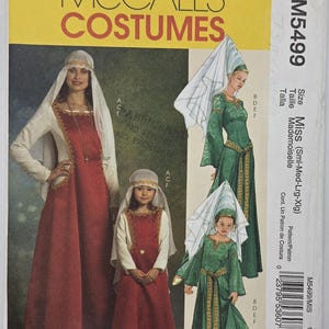 May include: A McCall's Costumes sewing pattern envelope M5499 for Miss and child sizes. The cover features illustrations of long dresses with long sleeves, decorative trim, and headpieces in red and green colorways, with text including M5499.