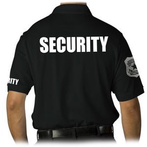 May include: Black polo shirt with the word "SECURITY" printed in large white letters across the back. The sleeve has the word "RITY" printed in white. A security officer badge is on the right sleeve.