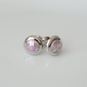 以下が含まれることがあります： ピンクの真珠貝のインレイが付いた銀製のカフスボタンのペア