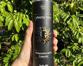 May include: A black and gold candle with the text "Celestial Bliss" and "Bienaventuranza Celestial" with a sun and moon graphic. The candle is blue and has a net weight of 300g.