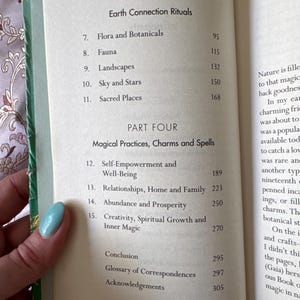May include: Open book with a green cover, displaying a table of contents. The headings include "Earth Connection Rituals" and "Magical Practices, Charms and Spells." Topics listed are Flora, Fauna, Landscapes, Sky, Stars, and Sacred Places.