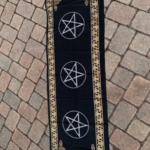May include: Black altar cloth with a gold Celtic knot border and three silver pentagrams.