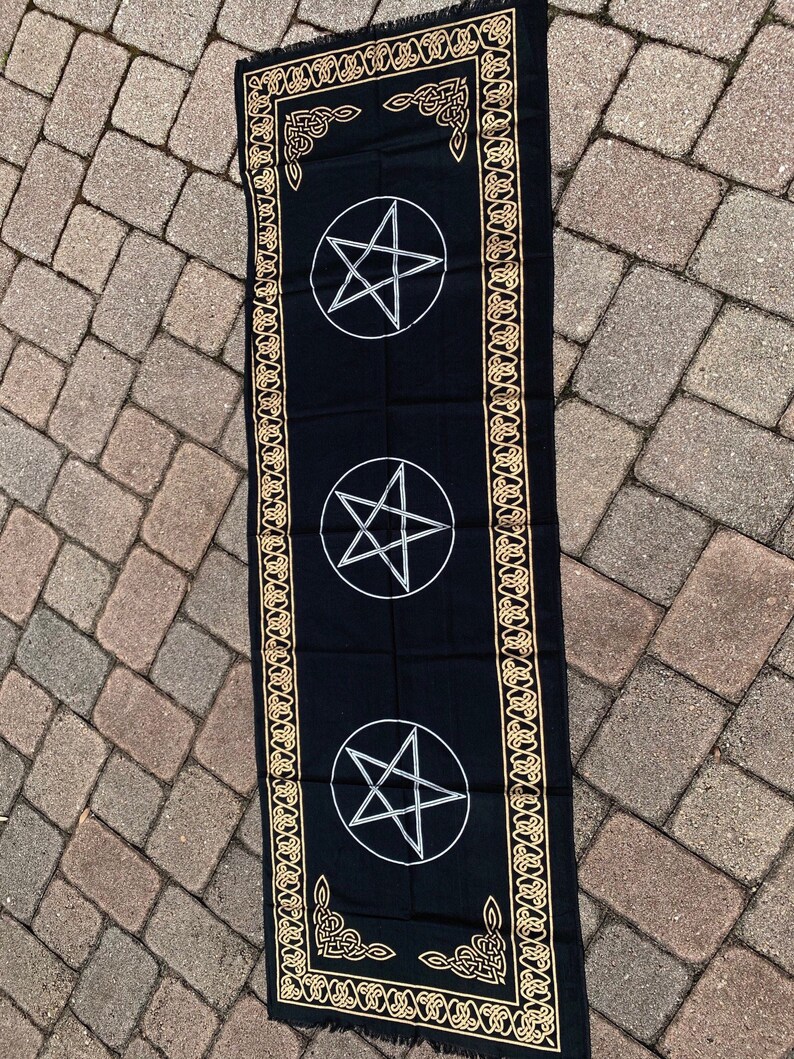 May include: Black altar cloth with a gold Celtic knot border and three silver pentagrams.