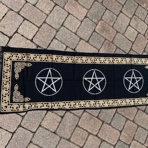 May include: Black altar cloth with a gold Celtic knot border and three silver pentagrams.
