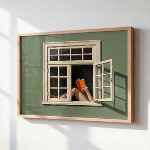 May include: A framed wall art print featuring a sage green wall with a white window frame. One window pane is open, revealing a person reading an orange book. The scene includes a light wood frame and shows shadows cast by the window structure.