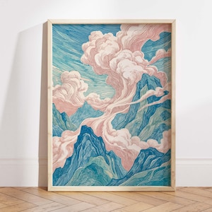 May include: A framed art print featuring a mountain landscape with pink clouds and a blue sky. The mountains are rendered in shades of blue and green, creating a serene and natural scene. The artwork is encased in a light-colored wooden frame.