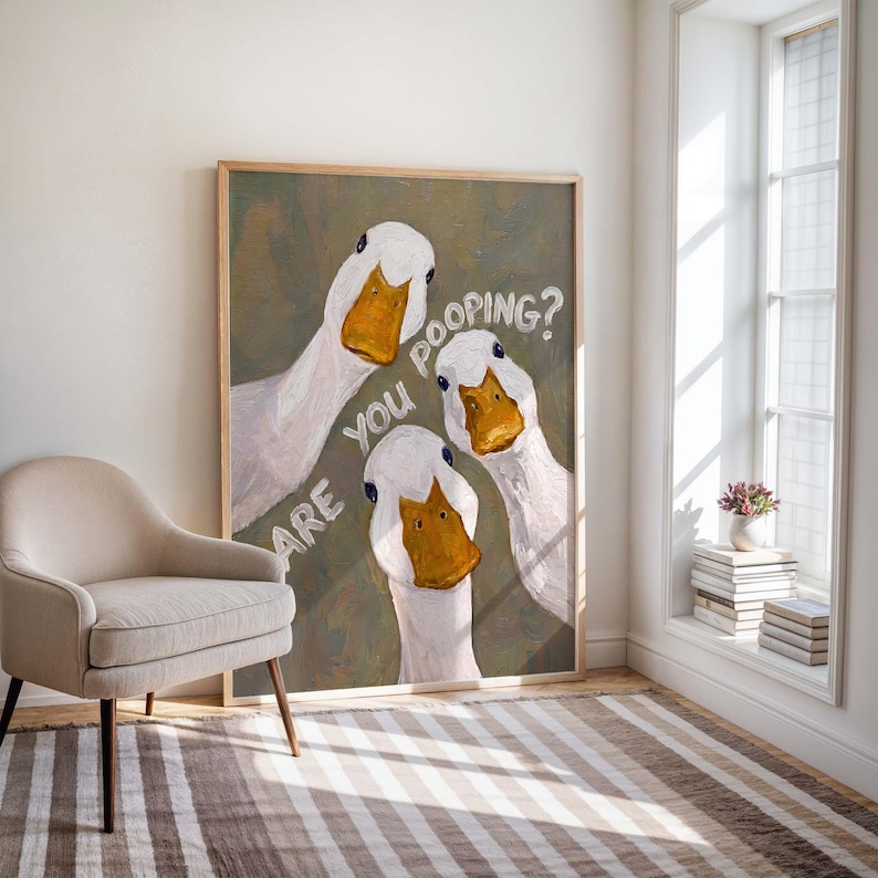 May include: A rectangular framed wall art print featuring an oil painting of three white ducks with bright orange beaks against a muted olive green background. The white text overlaid on the image reads, "ARE YOU POOPING?" in a casual font.