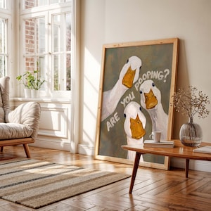 May include: A rectangular framed wall art print featuring an oil painting of three white ducks with orange beaks against a muted olive green background. The text "ARE YOU POOPING?" is written in white, slightly curved lettering across the canvas.