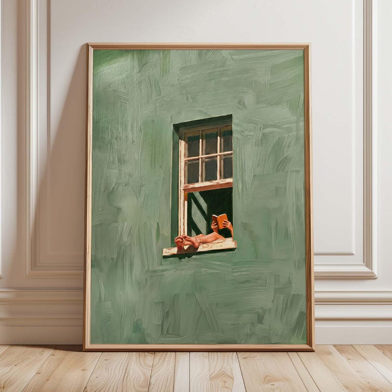 May include: A framed art print depicts a person reading a book by a window. The wall is painted in shades of green with visible brushstrokes. The window frame is light brown, and the book is orange.