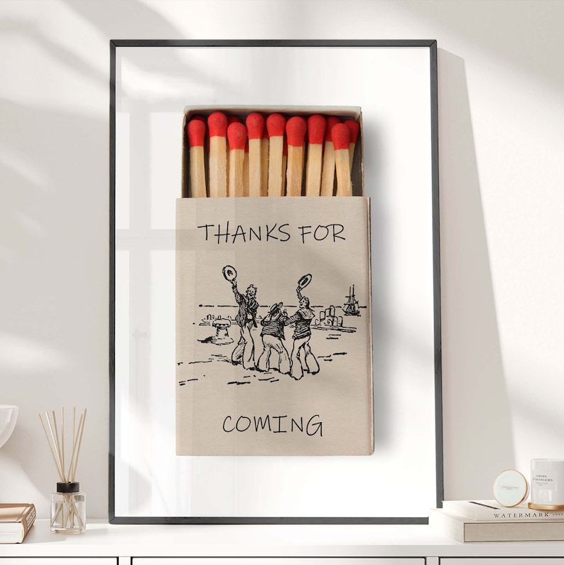 May include: A vintage-style matchbox with a red and white design. The matchbox has a black and white illustration of three men in hats and the text "THANKS FOR COMING".